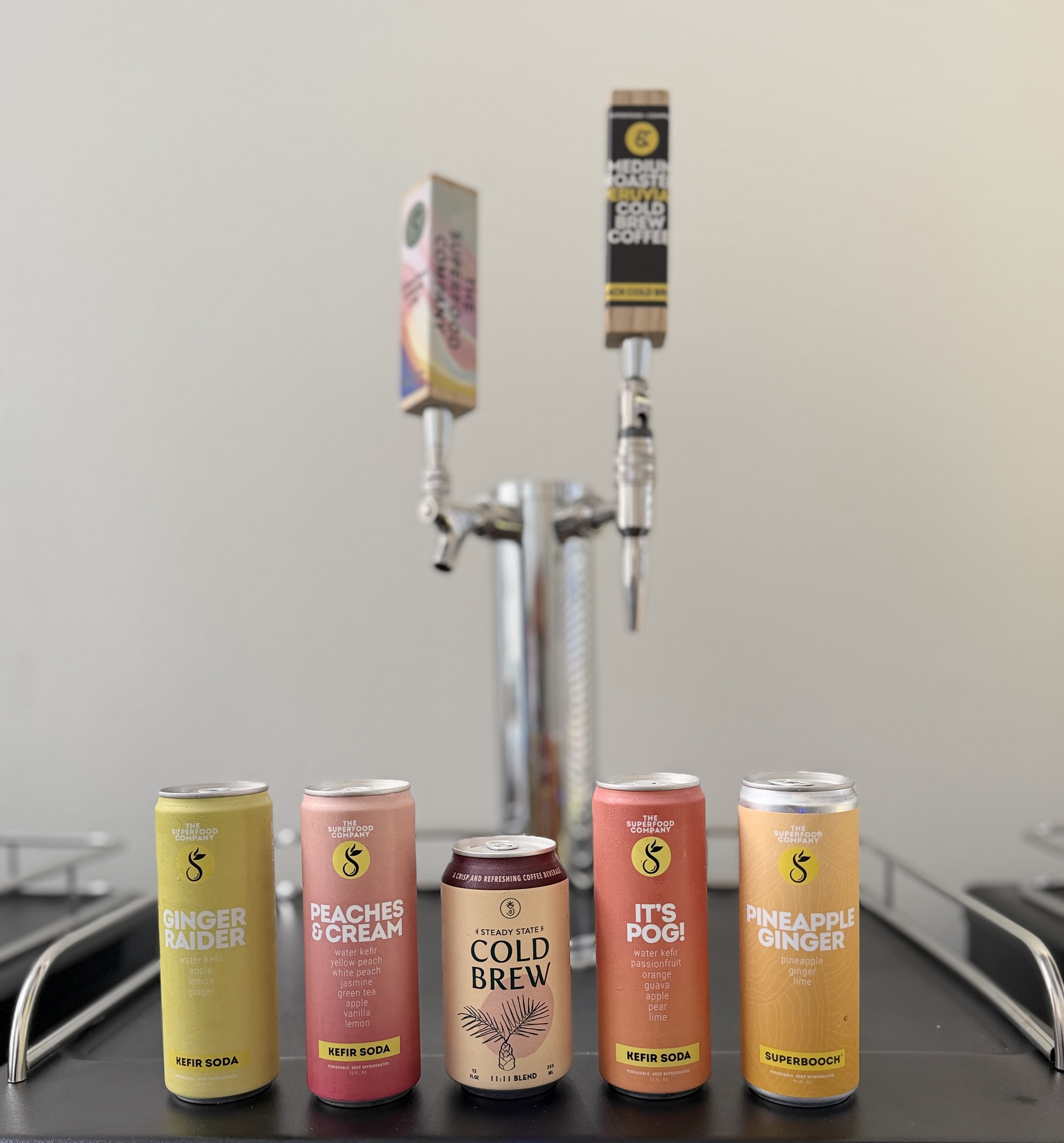 A Perpetual tap tower with a lineup of colorful cold-brew, kombucha, and kefir-soda cans